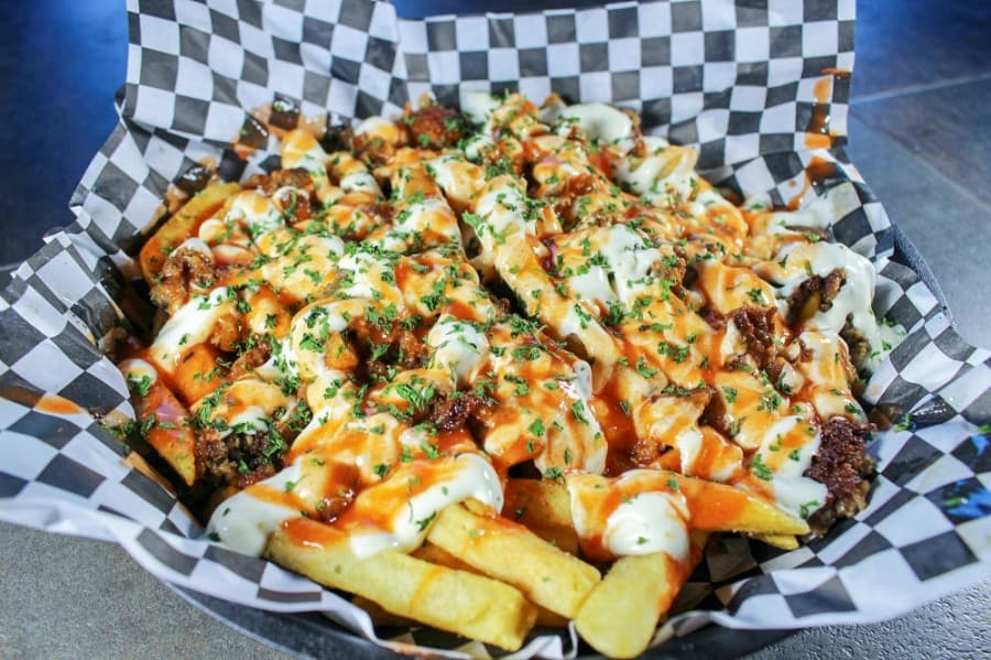 Monster Fries (0.99): seasoned fries topped with beef and lamb gyro meat, homemade garlic sauce and cayenne pepper sauce. (Kelly Schafler/Community Impact Newspaper)