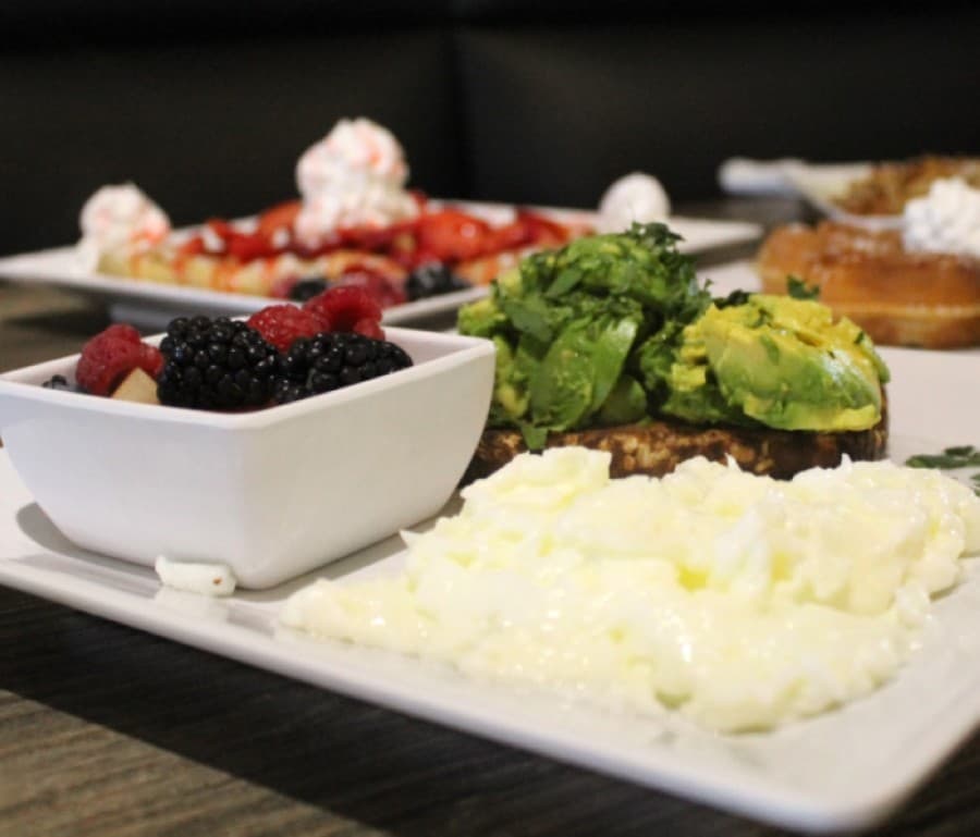 The Avocado Toast ($10.50) has fresh avocado, egg whites and fresh fruit. (Ian Pribanic/Community Impact Newspaper)