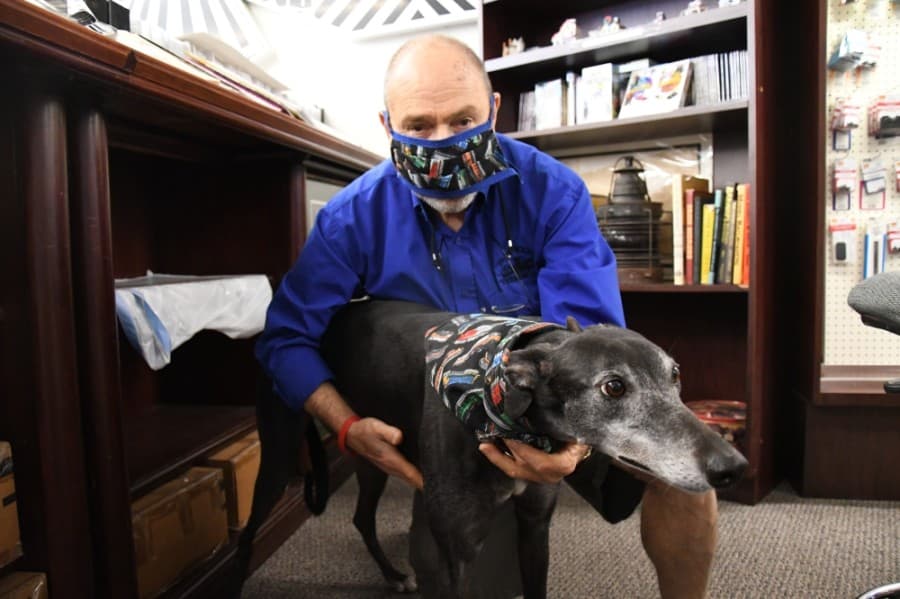 Papa Ben’s Train Place owner Allyn Perlman and his dog, 8-year-old greyhound, Sonoma, can be seen greeting customers. (Hunter Marrow/Community Impact Newspaper)
