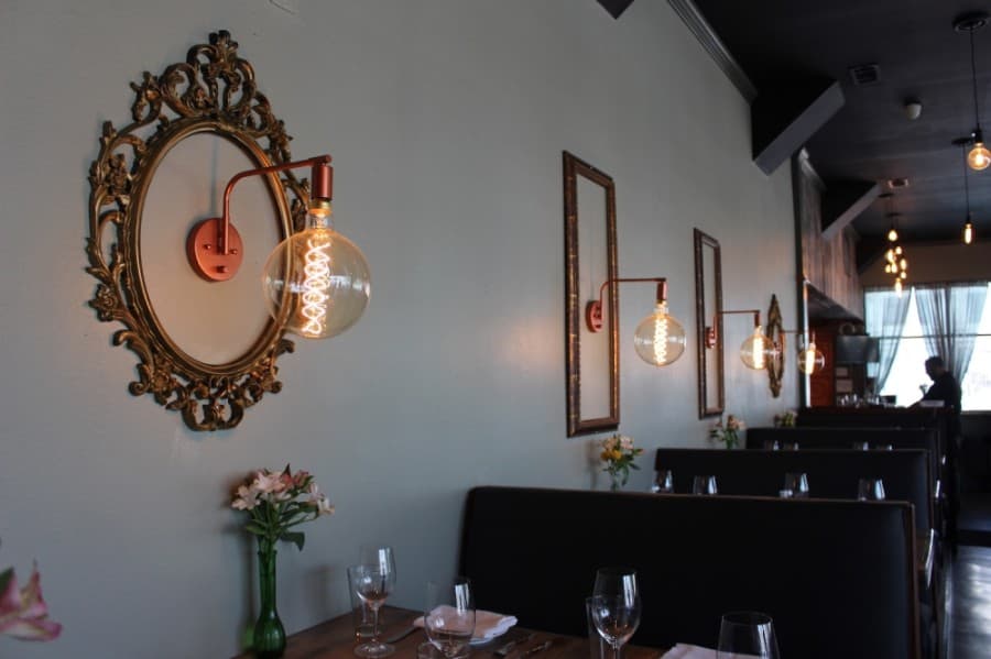 Light fixtures framed in gold are some of the details that were put into McKinney's new restaurant, CT Provisions. (Miranda Jaimes/Community Impact Newspaper)