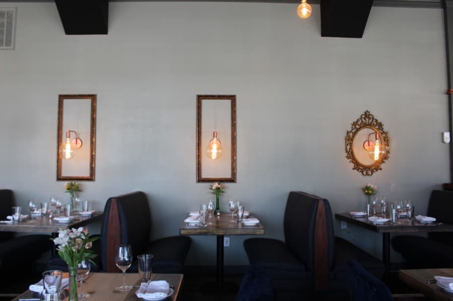 Light fixtures framed in gold are some of the details that were put into McKinney's new restaurant, CT Provisions. (Miranda Jaimes/Community Impact Newspaper)