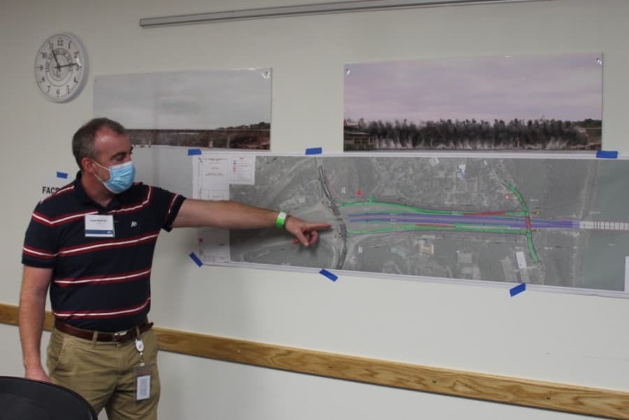 Lucas Short, the project manager for the Loop 360 Project, points out features of the planned diverging diamond intersection at the RM 2222 intersection during the Oct. 6 public hearing. (Brian Perdue/Community Impact Newspaper)