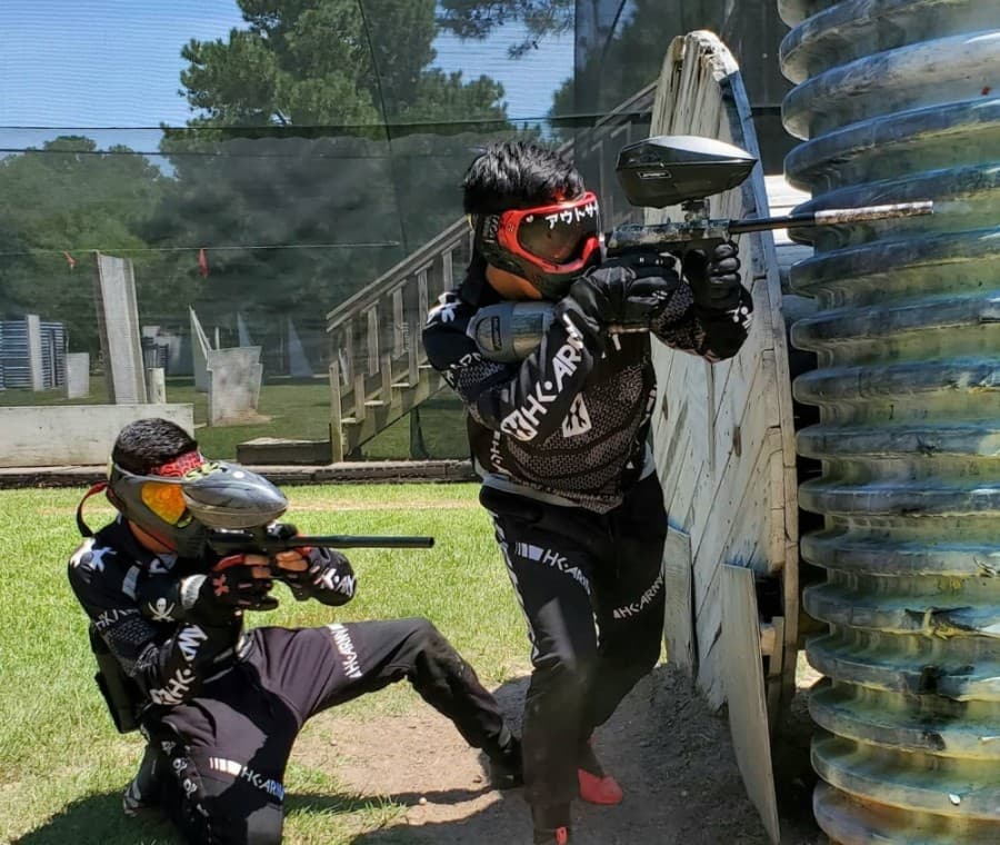 Two players on the same team take aim behind an obstacle at TXR Paintball. (Courtesy TXR Paintball)