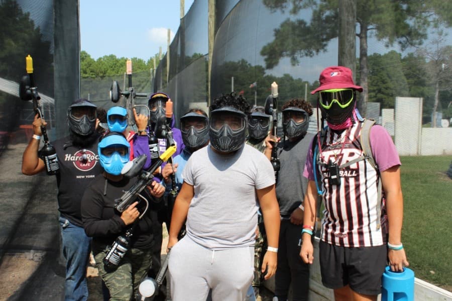 A group of players in a birthday party pose with a park referee before entering a match. (Shawn Arrajj/Community Impact Newspaper)