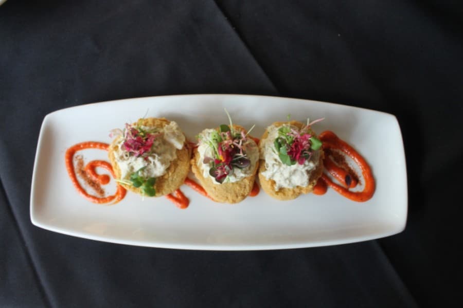 Fried green tomatoes topped with lump crab and microgreens ($12) (Colleen Ferguson/Community Impact Newspaper)