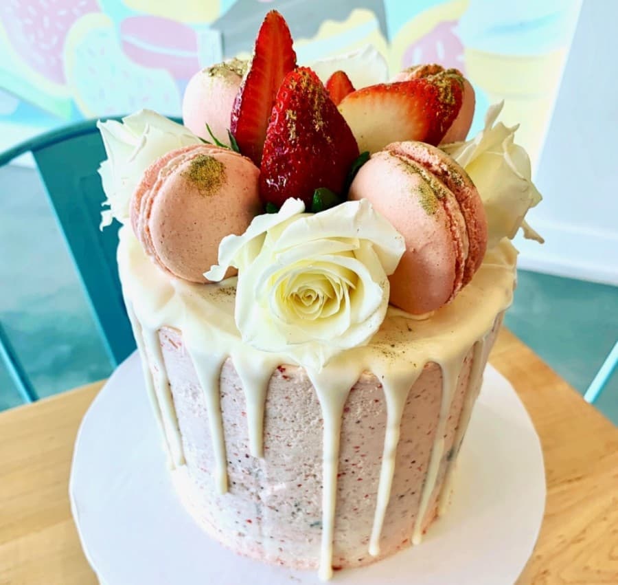 'The Luliet' signature cake (2-6) is a buttercream cake with a white chocolate drip and topped with macarons and fresh flowers. (Courtesy Luliet Creamery + Bake Shop)