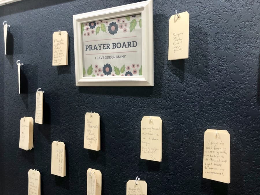 Patrons may take and leave prayer requests on the shop's prayer board. (Sally Grace Holtgrieve/Community Impact Newspaper)