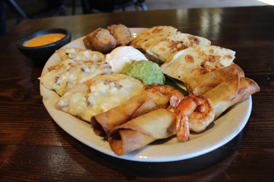 Fiesta supreme: Chicken fajita nachos and quesadillas are served with flautitas and more. (Daniel Houston/Community Impact Newspaper)