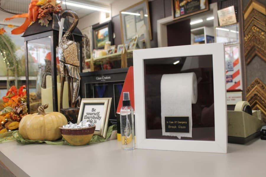 Tate has framed many unique objects during his time in the business; he framed a roll of toilet tissue when the coronavirus pandemic hit Texas. (Colleen Ferguson/Community Impact Newspaper)