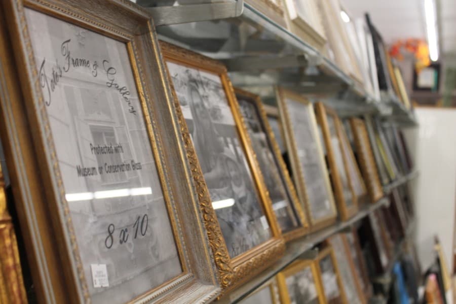 Owner Randall Tate and his wife and son make all frames in-house. (Colleen Ferguson/Community Impact Newspaper)