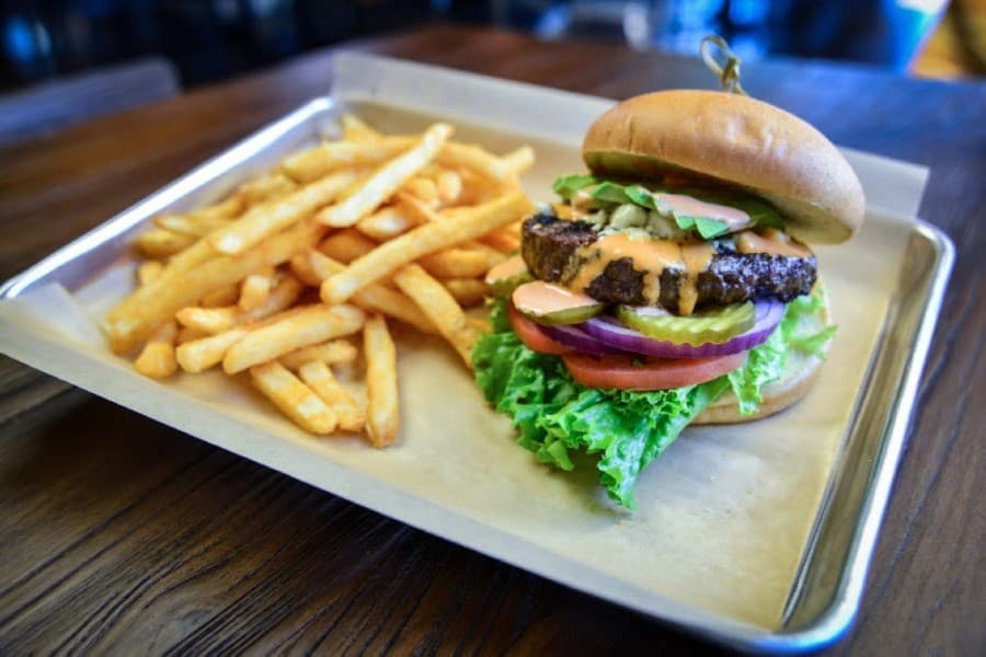 The All Aboard Burger ($13.50) comes with blue cheese crumbles, chipotle sauce and avocado. (Courtesy The Station Patio Icehouse)