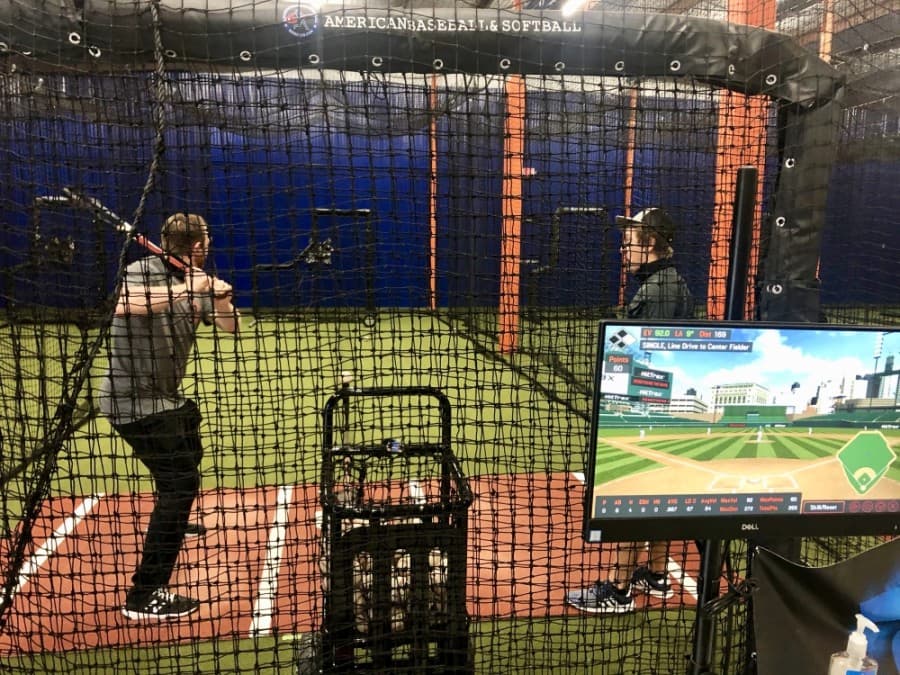 Dustin Geiger (right), a hitter who has played with the Chicago Cubs and Miami Marlins in the minor leagues, utilizes the center's data-gathering technology. (Sally Grace Holtgrieve/Community Impact Newspaper)