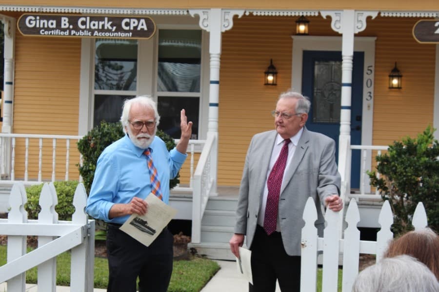 Grandson Henry Dean, left, shared memories of the home and of Magnolia past with community members during the marker dedication. Larry Foerster, right, chairman of the Montgomery County Historical Commission, led the dedication ceremony Oct. 26. (Anna Lotz/Community Impact Newspaper) 
