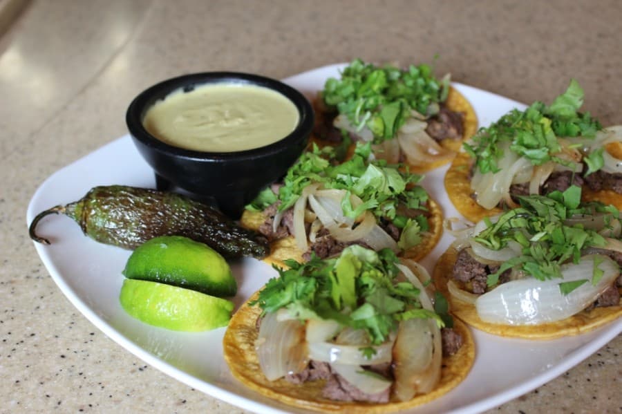 The beef fajita Street Tacos ($9.99) are served on corn tortillas with grilled onion, cilantro and a grilled jalapeño. (Adriana Rezal/Community Impact Newspaper)