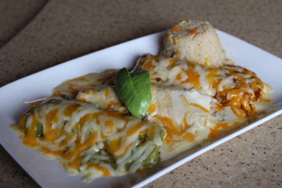 The Pollo Felis ($10.19) includes three chicken enchiladas topped with a tomatillo poblano cream and ranchero sauce. (Adriana Rezal/Community Impact Newspaper)