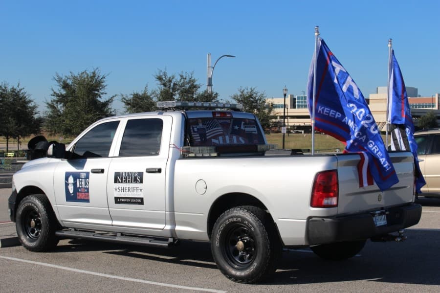 This truck parked outside the Sugar Land Smart Financial Centre had Trump flags as well as stickers showing support for Republicans Troy and Trever Nehls. (Claire Shoop/Community Impact Newspaper)