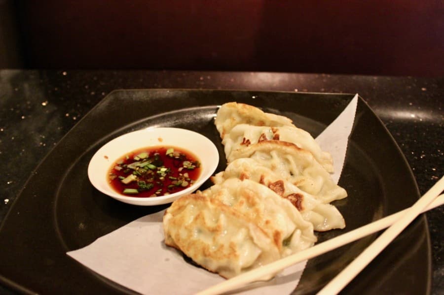 Mandoo is a pan-fried Korean dumpling served with a soy-based dipping sauce. (Taylor Jackson Buchanan/Community Impact Newspaper)