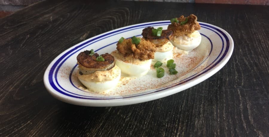 Huevos, $8.95: Four deviled eggs with choice of fried oysters, blackened shrimp or both. (Haley Morrison/Community Impact Newspaper)