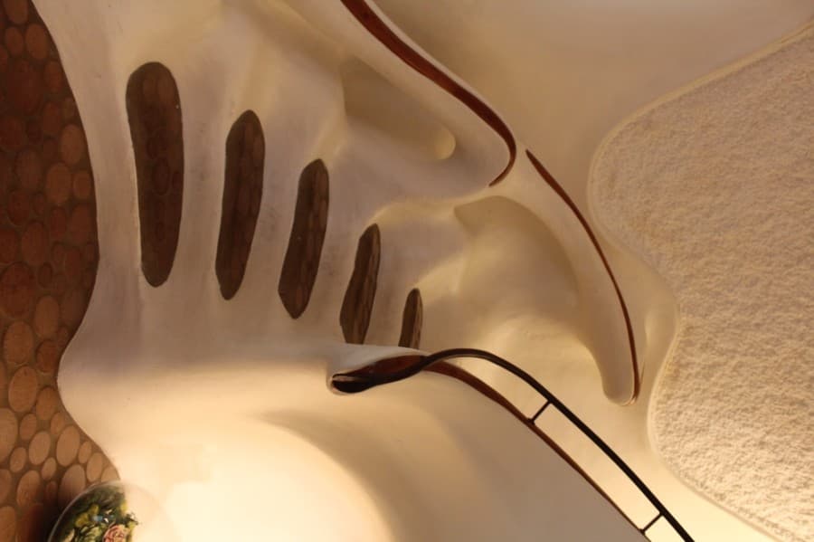 The winding staircase features cherry wood accents.