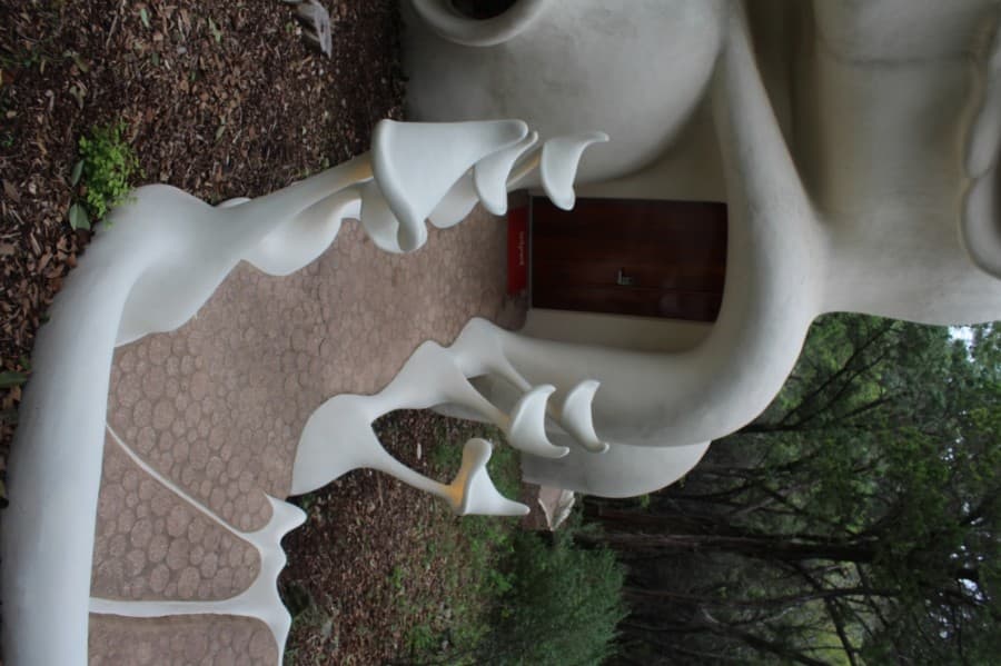 The walkway to the front door is flanked by conical nightlights.