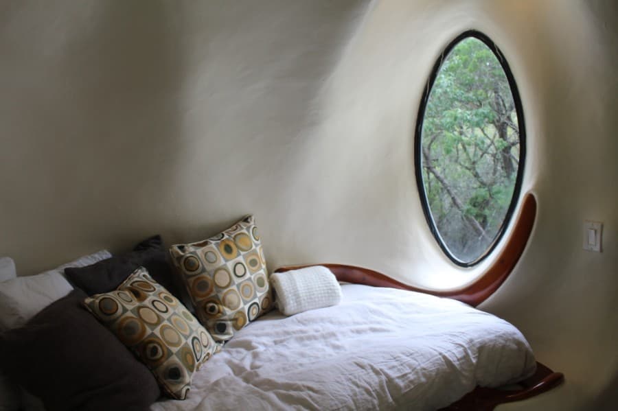 The daybed in the loft overlooks a ravine.