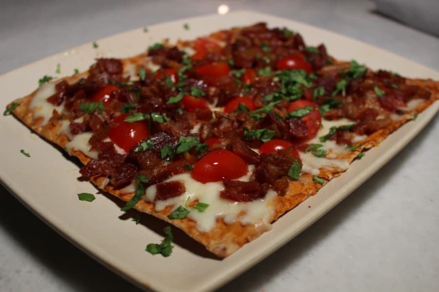 The BLT lavash flatbread consists of tomato sauce, mozzarella, bacon, arugula and tomato.  $12.99. (Andrew Christman/Community Impact Newspaper)