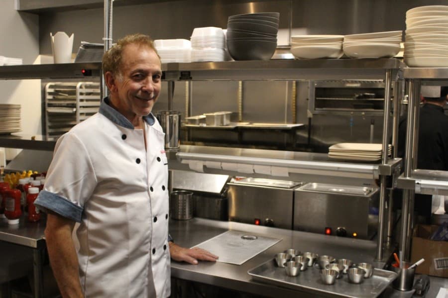 Owner and chef Charlie Watkins runs the kitchen at Burger and Bordeaux.  (Andrew Christman/Community Impact Newspaper)