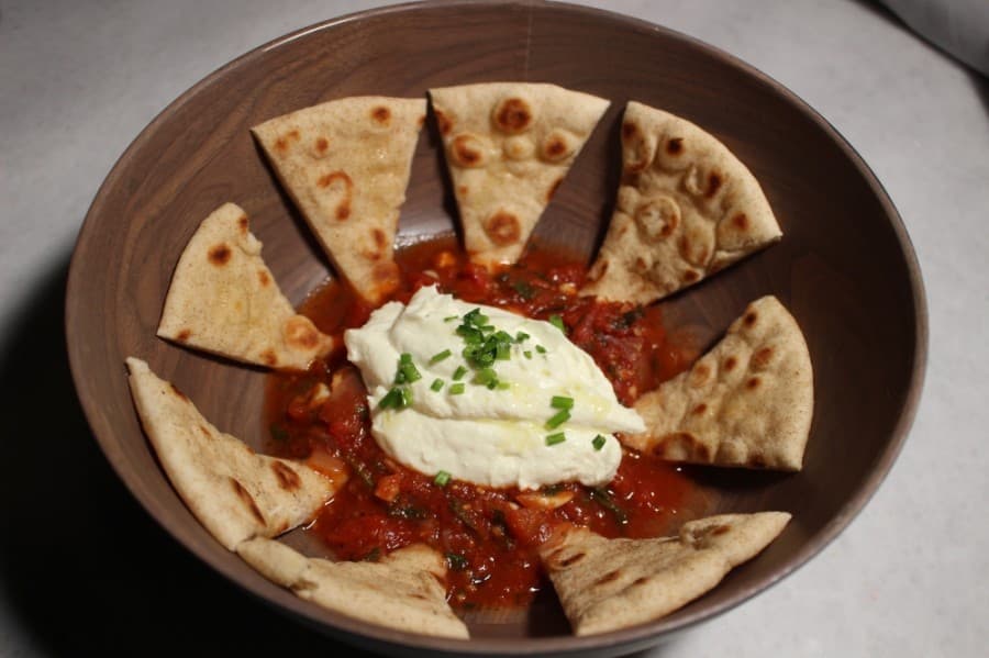 Among the appetizers is warm goat cheese with basil tomato coulis and pita. $12.99. (Andrew Christman/Community Impact Newspaper)