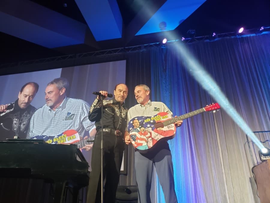 Singer Lee Greenwood (right) and Kalahari founder and CEO Todd Nelson were on stage at the Nov. 14 grand opening Nov. 14. (Ali Linan/Community Impact Newspaper)
