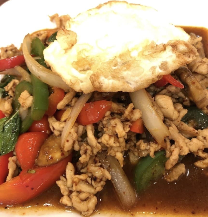 The Phad Basil is served with mushroom, jalapeno, onion, bell pepper, basil and a sunny side egg. (Courtesy Thai Curry)