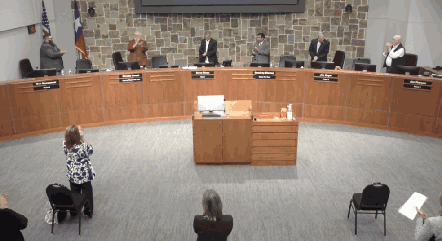 Outgoing Council Member Claudio Forest (second from left) receives a standing ovation Nov. 16 from his colleagues and the audience in recognition of his time with the town. (Screenshot from town of Flower Mound video)