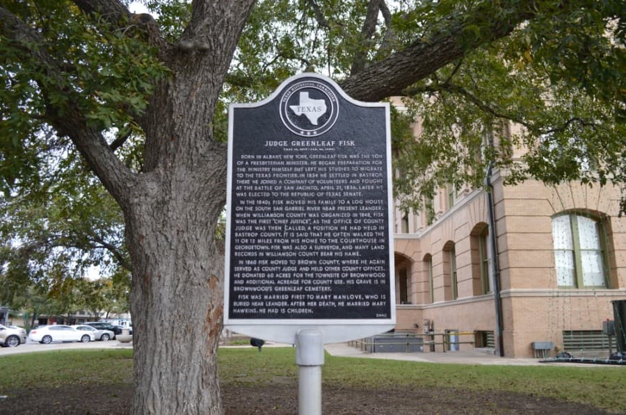 A Texas Historical Commission plaque in front of the Williamson County Courthouse shares the history of Greenleaf Fisk, his work and his family. (Taylor Girtman/Community Impact Newspaper)