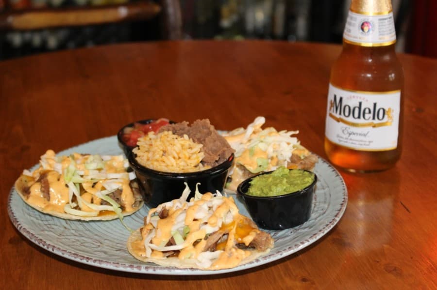Three pulled pork street tacos ($9.99) are served with shredded cheddar cheese, cabbage and Market Street Cafe’s chipotle Caesar dressing. (Adriana Rezal/Community Impact Newspaper)