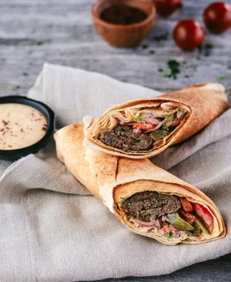 At the in-house food counter S Grill, customers can order the Kefta Pita Wrap ($7), which is made with ground beef and lamb, tahini sauce, tomato, pickles, parsley and onion. (Courtesy Sara's Market & Bakery)