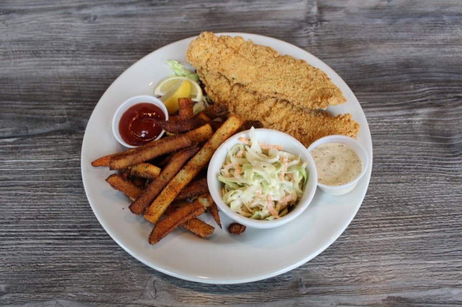 The Fried Catfish Platter ($13.95) features cornmeal crusted catfish deep fried, served with seasoned fries, coleslaw and Cajun remoulade. (Francesca D’Annunzio/Community Impact Newspaper)
