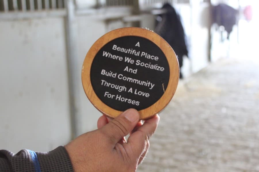A pendant Callegari had made to celebrate the center's 20th anniversary features the mission for what he said he wants his business to be. (Shawn Arrajj/Community Impact Newspaper)