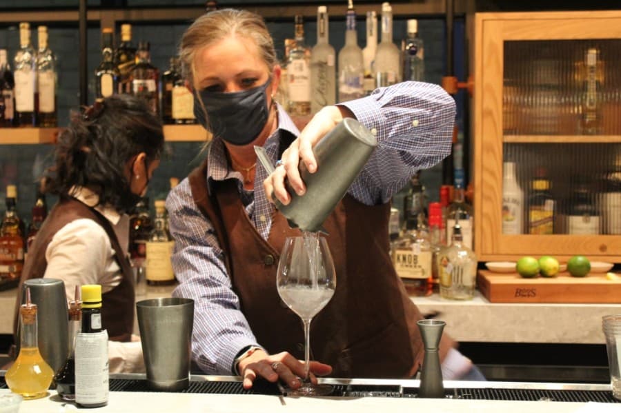 A bartender pours a drink for a guest during the Delta Hotels ribbon-cutting ceremony Dec. 9. (Sandra Sadek/Community Impact Newspaper)
