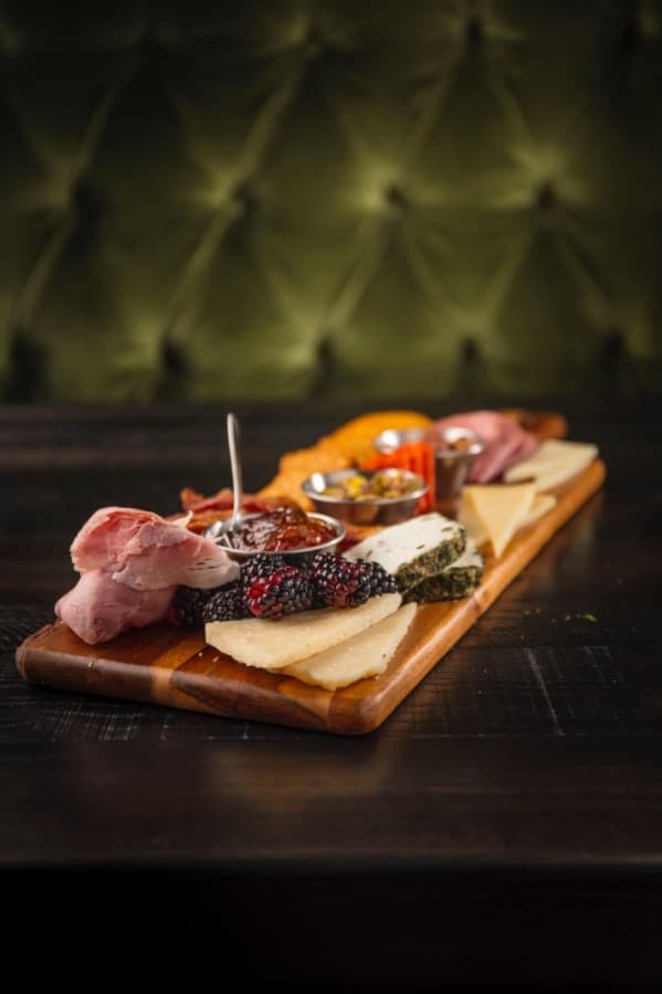 This charcuterie board appetizer is served with a variety of meats and artisan cheeses alongside fresh fruits, nuts and Tabasco jelly. (Courtesy Rustico Wood Fired Grill & Wine Bar)