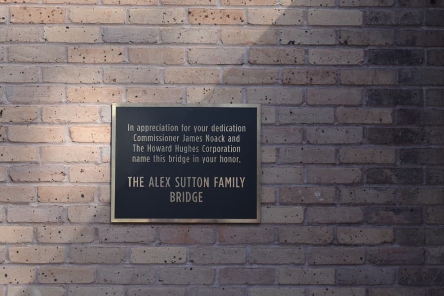 A plaque on the bridge dedicates the site to the Alex Sutton family. (Vanessa Holt/Community Impact Newspaper)