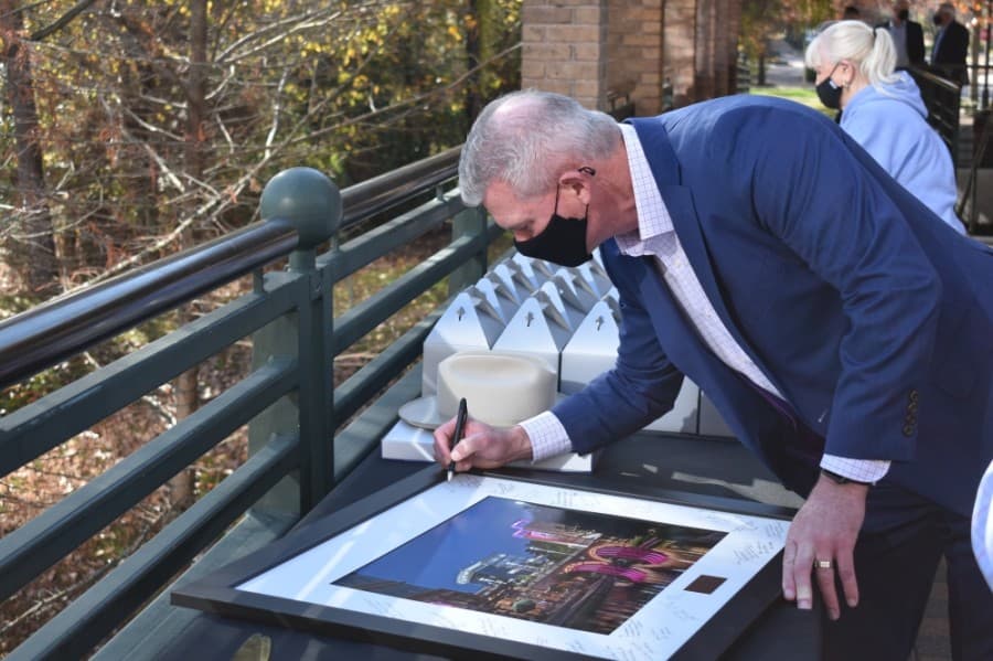 Community leaders, including J.J. Hollie, president of The Woodlands Area Chamber of Commerce, signed a commemorative photo for Sutton. (Vanessa Holt/Community Impact Newspaper)