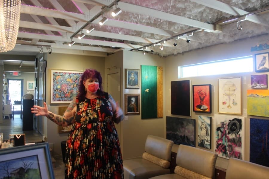 Creative director Lynnie Goodman tours her gallery. (Olivia Aldridge/Community Impact Newspaper)