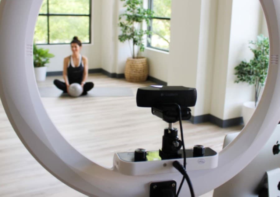 Vessel Pilates owner Jessica Sowyrda streams workouts to clients. (Kelly Schafler/Community Impact Newspaper)