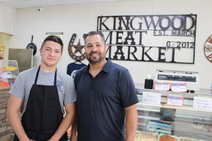 Eduardo Garza, right, opened Kingwood Meat Market with his wife, Jennifer, in 2012. His son, Miguel, left, and daughter, Emily, help run the business. (Kelly Schafler/Community Impact Newspaper)
