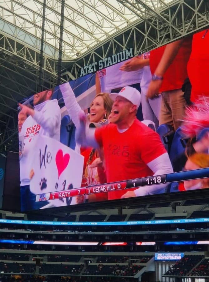 Jeremy Koger, father of quarterback Caleb Koger, and his friend, Robyn West, cheer after the first Katy touchdown during the state championship game Jan. 16. (Courtesy Dana Congleton Koger)