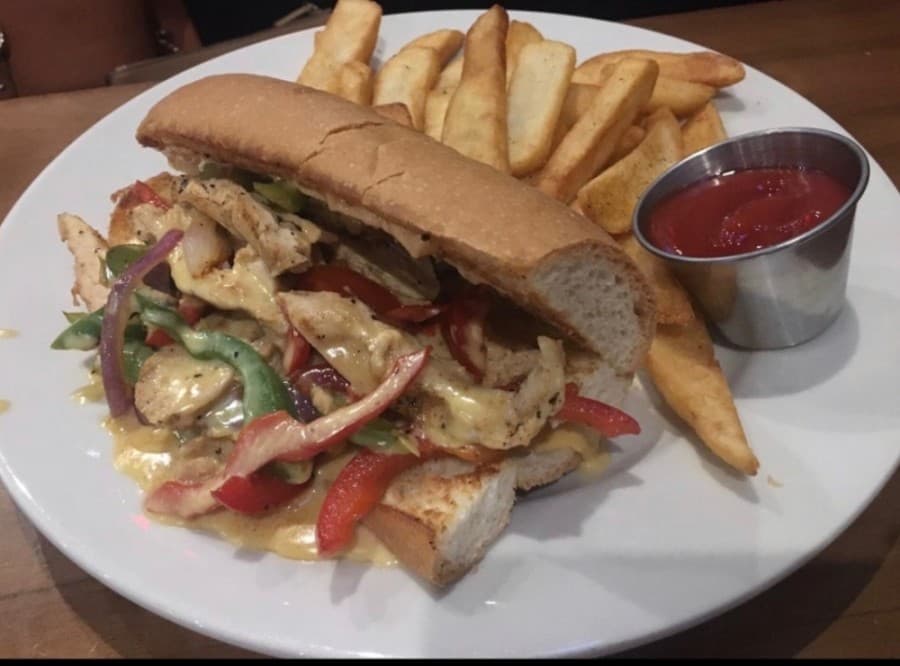 The queso chicken Philly ($13) comes with grilled chicken, peppers, onions, beer queso and chipotle mayonnaise. 