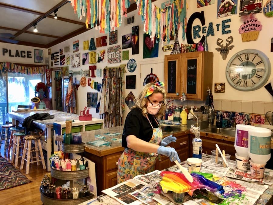 Art Barn ATX owner Amber Gordon uses resin on a project. (Sally Grace Holtgrieve/Community Impact Newspaper)