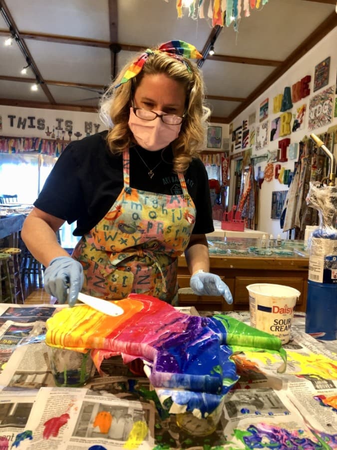 Art Barn ATX owner Amber Gordon uses resin on a project. (Sally Grace Holtgrieve/Community Impact Newspaper)