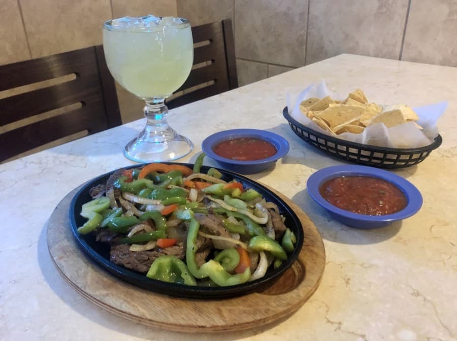 Steak fajitas are a popular menu item and are shown here with chips, salsa and a margarita. (Sally Grace Holtgrieve/Community Impact Newspaper)