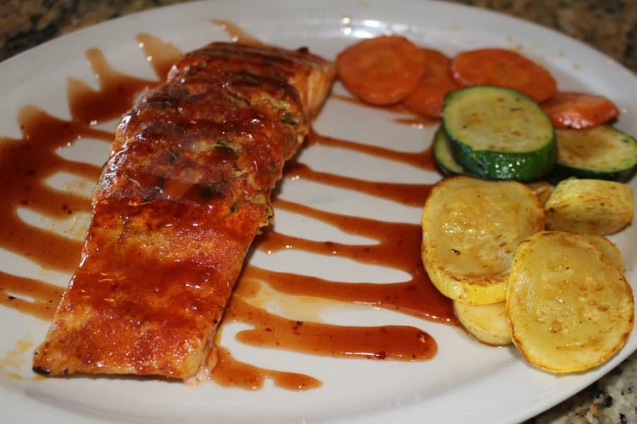 The Sunset Stuffed Salmon ($24.75) is a large salmon filet crammed with crabmeat stuffing and topped with a sweet and spicy hot sauce. (Eva Vigh/Community Impact Newspaper)