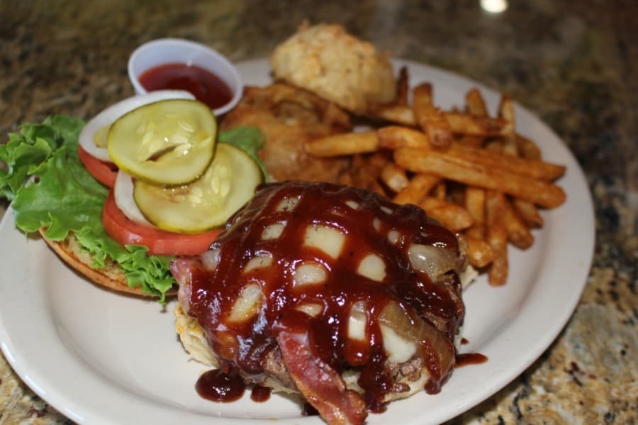 Harry’s Burger ($11.75) includes applewood bacon, pepper jack cheese and sauteed onions topped with barbecue sauce and served on a jalapeno bun. (Eva Vigh/Community Impact Newspaper)